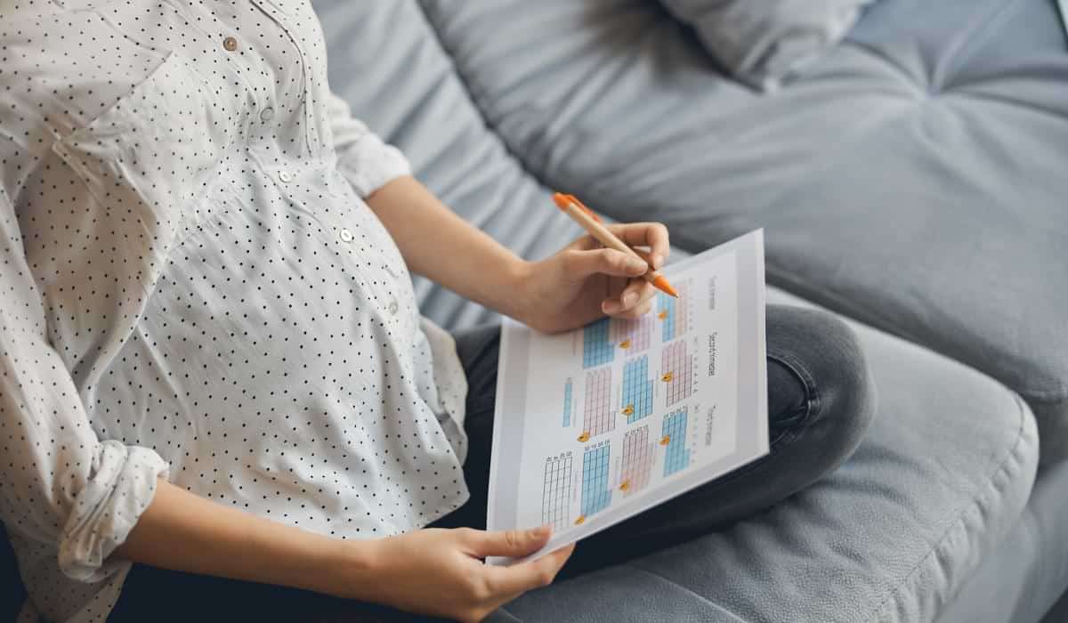 Pregnant woman looking at a calendar